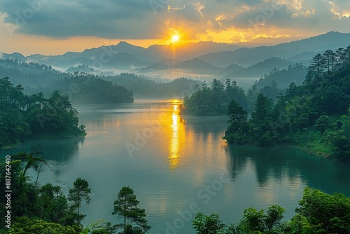 Tranquil sunrise over a serene lake in the heart of a lush green mountain valley photo