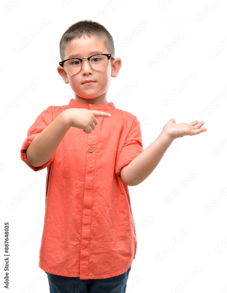 Dark haired little child wearing glasses very happy pointing with hand and finger Dark haired little child wearing glasses very happy pointing with hand and finger