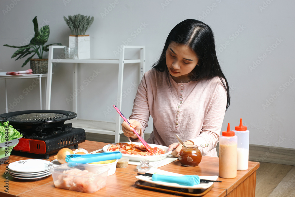 Young Asian Woman Preparing Beef Slices With Spice It Up Meat. Asian BBQ Food Style, Grilled Beef Sirloin Meat, Korean BBQ style.
Young Asian Woman Preparing Beef Slices With Spice It Up Meat. Asian BBQ Food Style, Grilled Beef Sirloin Meat, Korean BBQ style.