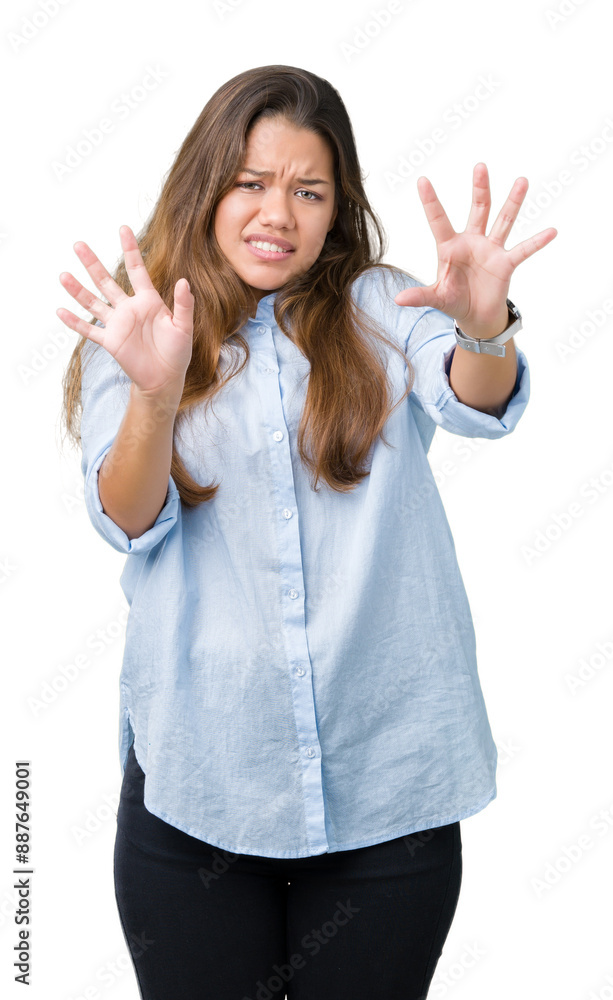Young beautiful brunette business woman over isolated background afraid and terrified with fear expression stop gesture with hands, shouting in shock. Panic concept. Young beautiful brunette business woman over isolated background afraid and terrified with fear expression stop gesture with hands, shouting in shock. Panic concept.