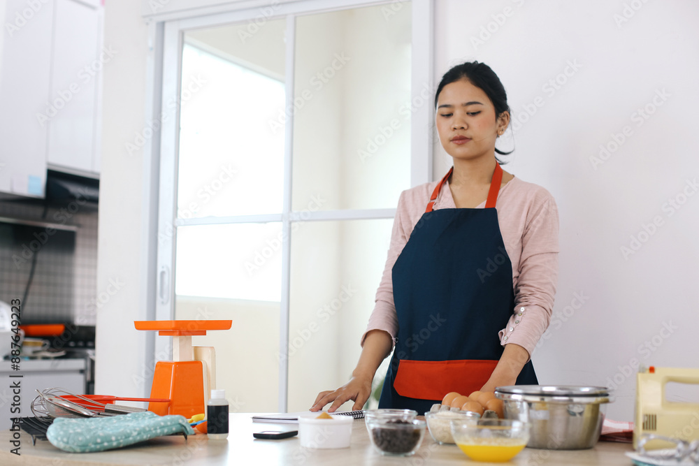 Young Asian Woman Preparing Ingredients For Making Cake Young Asian Woman Preparing Ingredients For Making Cake