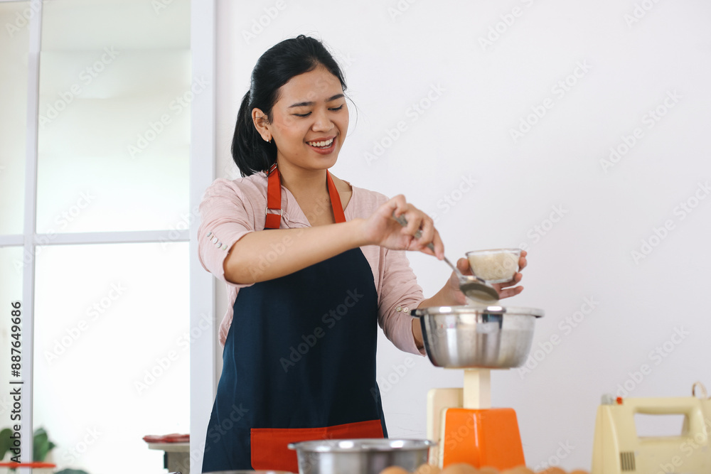 Cheerful Young Asian Woman Hands Add Sugar Into The Bowl To Measure The Weight. Getting Ready To Make Cake Cheerful Young Asian Woman Hands Add Sugar Into The Bowl To Measure The Weight. Getting Ready To Make Cake