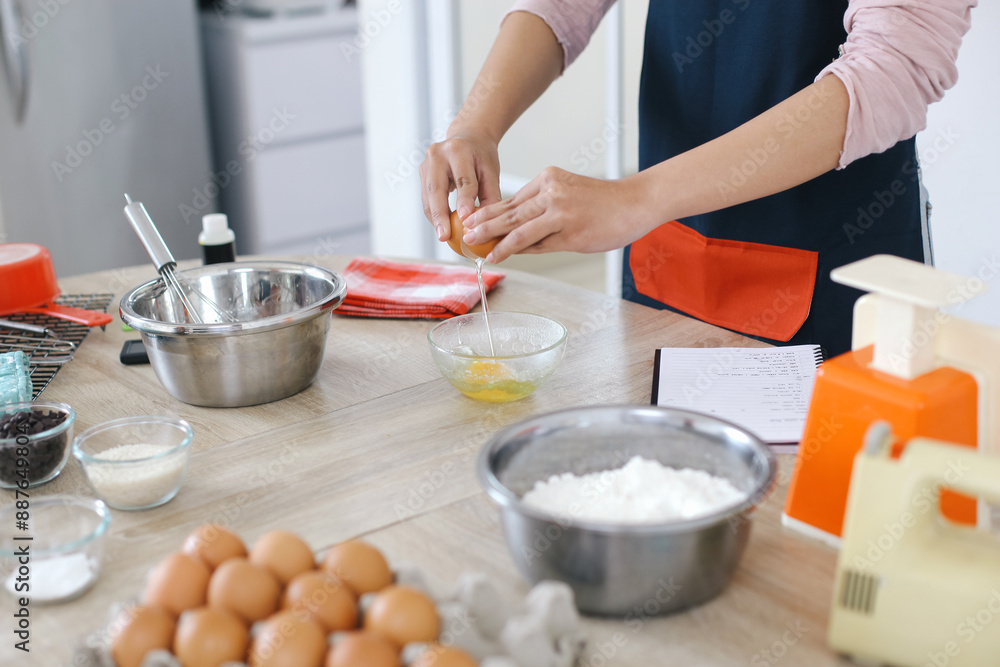 Hands Break Eggs Into Container To Prepare Ingredients For Making Cakes Hands Break Eggs Into Container To Prepare Ingredients For Making Cakes
