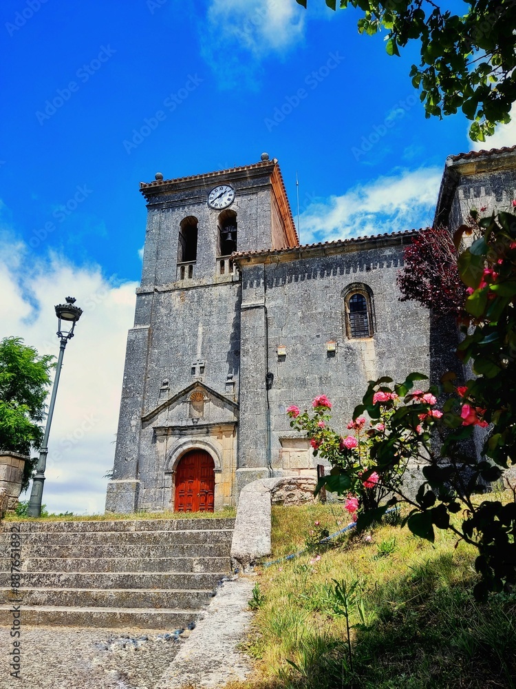 Fototapeta premium Church of Santa Marina, medieval building from Castilla with decorative flowers in a sunny day of summer