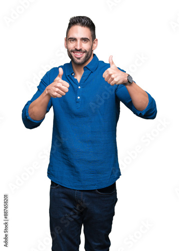 Young handsome man over isolated background success sign doing positive gesture with hand, thumbs up smiling and happy. Looking at the camera with cheerful expression, winner gesture.