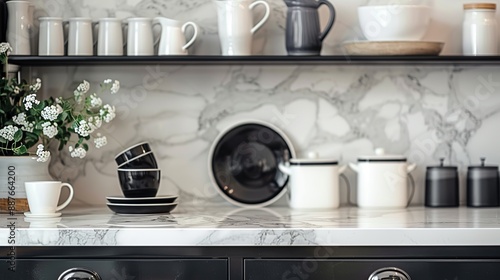 There is ceramic cookware on the display. Marble worktop. Kitchen design in black and white.