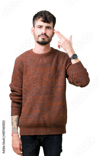 Canvas Print Young handsome man wearing winter sweater over isolated background Shooting and killing oneself pointing hand and fingers to head, suicide gesture