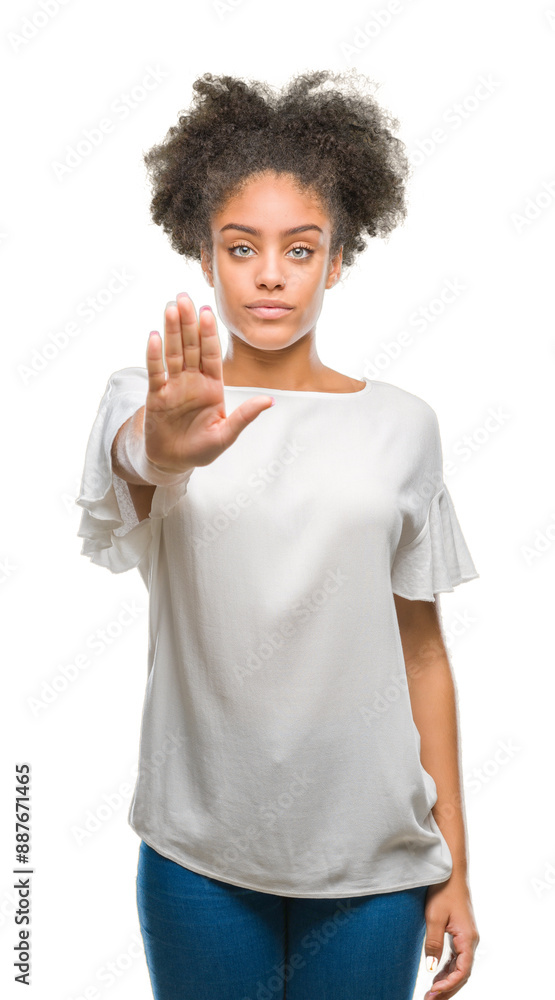 Young afro american woman over isolated background doing stop sing with palm of the hand. Warning expression with negative and serious gesture on the face. Young afro american woman over isolated background doing stop sing with palm of the hand. Warning expression with negative and serious gesture on the face.