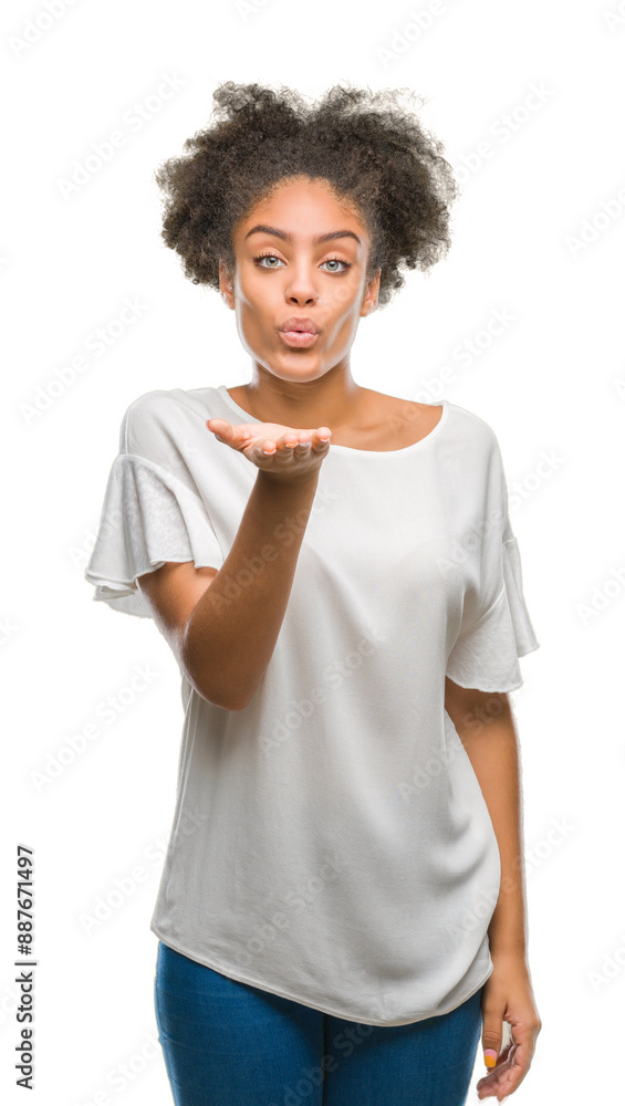 Young afro american woman over isolated background looking at the camera blowing a kiss with hand on air being lovely and sexy. Love expression. Young afro american woman over isolated background looking at the camera blowing a kiss with hand on air being lovely and sexy. Love expression.