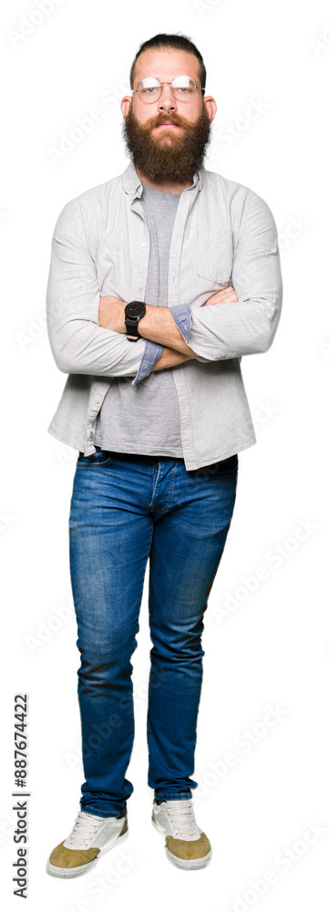 Fototapeta premium Young blond man wearing glasses skeptic and nervous, disapproving expression on face with crossed arms. Negative person.
