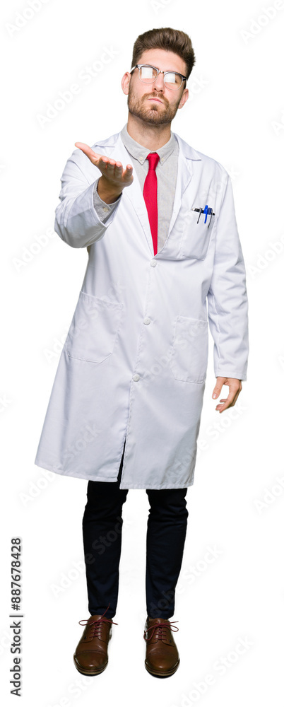 Young handsome scientist man wearing glasses looking at the camera blowing a kiss with hand on air being lovely and sexy. Love expression. Young handsome scientist man wearing glasses looking at the camera blowing a kiss with hand on air being lovely and sexy. Love expression.