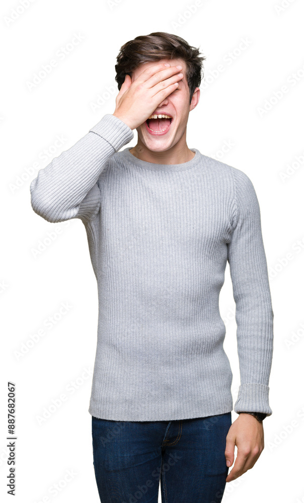 Young handsome man wearing winter sweater over isolated background smiling and laughing with hand on face covering eyes for surprise. Blind concept. Young handsome man wearing winter sweater over isolated background smiling and laughing with hand on face covering eyes for surprise. Blind concept.