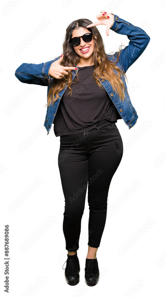 Young beautiful woman wearing sunglasses smiling making frame with hands and fingers with happy face. Creativity and photography concept. Young beautiful woman wearing sunglasses smiling making frame with hands and fingers with happy face. Creativity and photography concept.