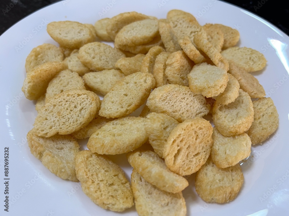 Crispy golden croutons on a white plate, perfect for adding crunch to salads and soups. Crispy golden croutons on a white plate, perfect for adding crunch to salads and soups.