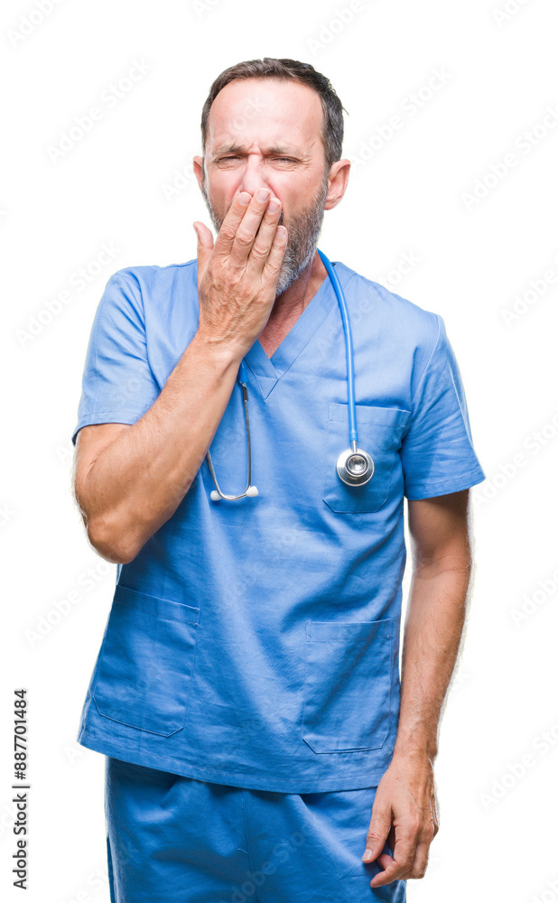 Middle age hoary senior doctor man wearing medical uniform over isolated background bored yawning tired covering mouth with hand. Restless and sleepiness. Middle age hoary senior doctor man wearing medical uniform over isolated background bored yawning tired covering mouth with hand. Restless and sleepiness.