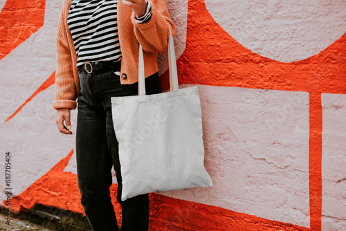 Tote bag png mockup reusable canvas bag carried by a model photo