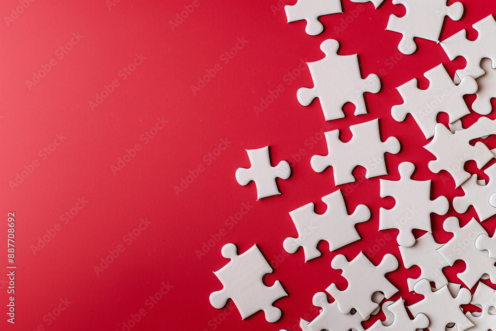 a group of white puzzle pieces on a red surface a group of white puzzle pieces on a red surface