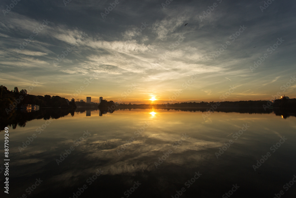 Park at sunrise with beautiful autumn colors and lake in background