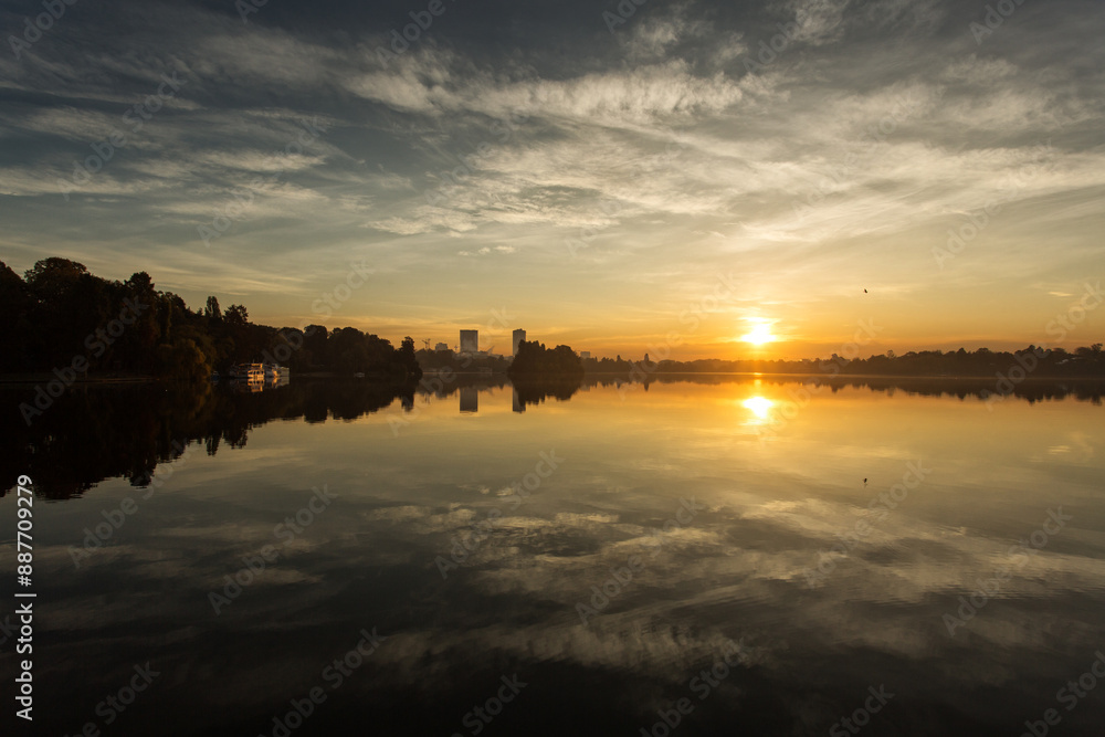 Park at sunrise with beautiful autumn colors and lake in background