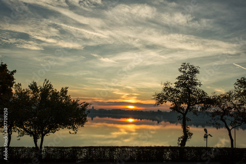 Park at sunrise with beautiful autumn colors and lake in background