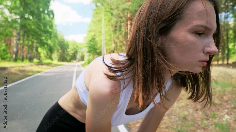 Sport and traumas concept. Young women jogger running and feeling acute pain in knee, massaging painful leg during morning run in park, close up, slow motion Sport and traumas concept. Young women jogger running and feeling acute pain in knee, massaging painful leg during morning run in park, close up, slow motion