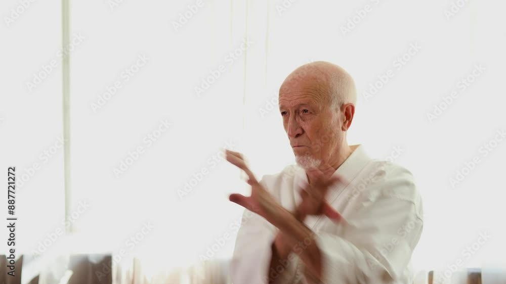 Old man trainer trains blocks with hands Old man trainer trains blocks with hands