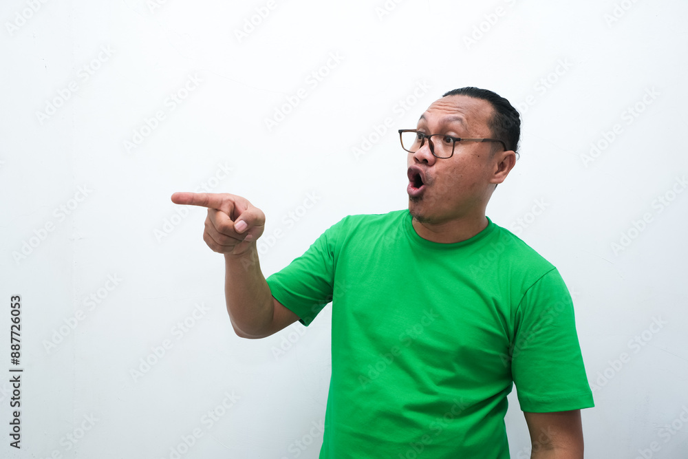 Asian man's shocked expression while pointing to the side