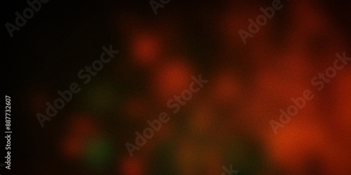 Abstract dark gradient background with warm red and green spots, creating a mysterious and dramatic atmosphere. Ideal for digital designs and artistic projects