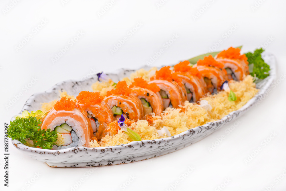 Salmon roll topped with shrimp eggs, set in a porcelain dish, ready to eat. Salmon roll topped with shrimp eggs, set in a porcelain dish, ready to eat.