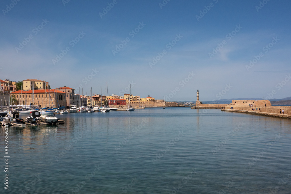 Fototapeta premium View over Rethymno harbour, blue water and blue sky, dam with Venetian lighthouse