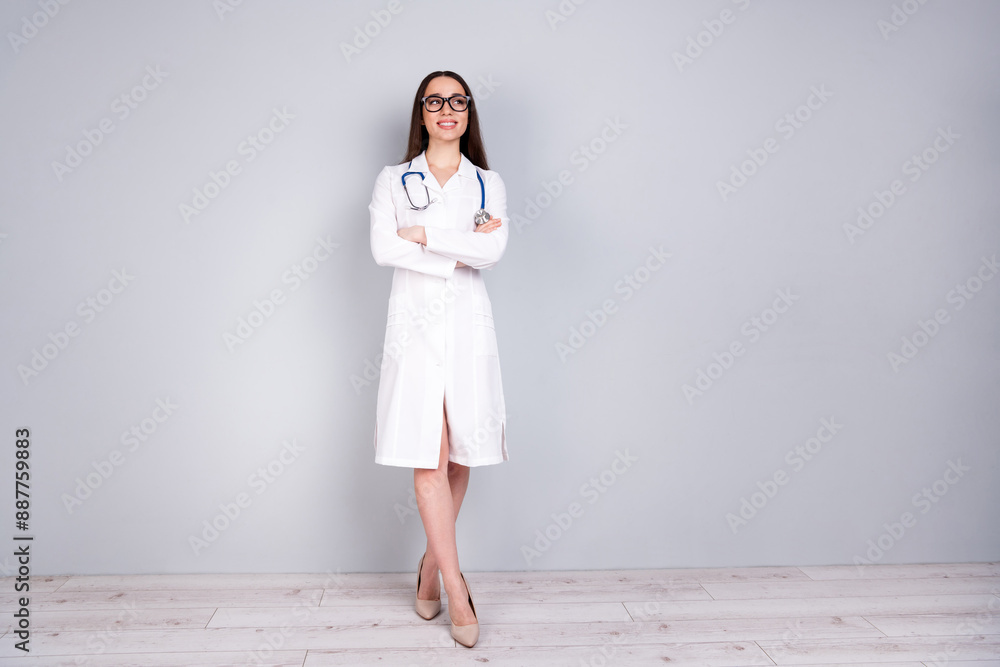 Photo of charming pretty woman doc assistant wear white doctor robe crossed arms look empty space isolated on grey color background Photo of charming pretty woman doc assistant wear white doctor robe crossed arms look empty space isolated on grey color background
