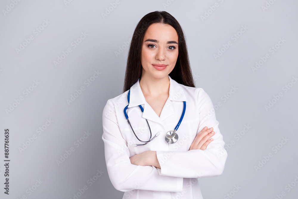Photo of professional medical worker lady folded arms empty space white coat isolated on grey color background Photo of professional medical worker lady folded arms empty space white coat isolated on grey color background
