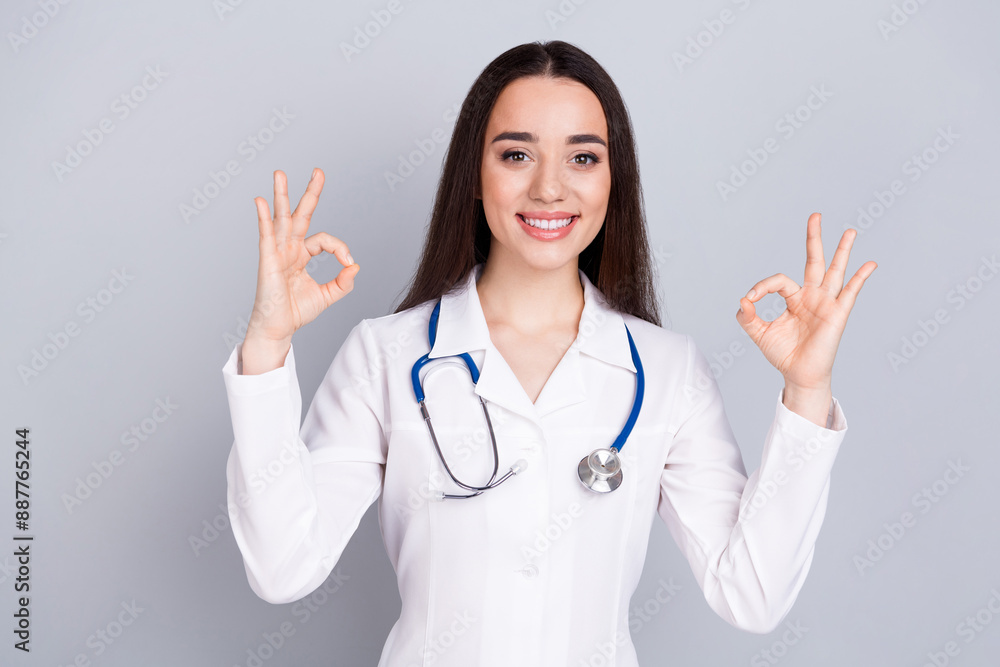Photo of professional medical worker lady show thumb up white coat isolated on grey color background Photo of professional medical worker lady show thumb up white coat isolated on grey color background