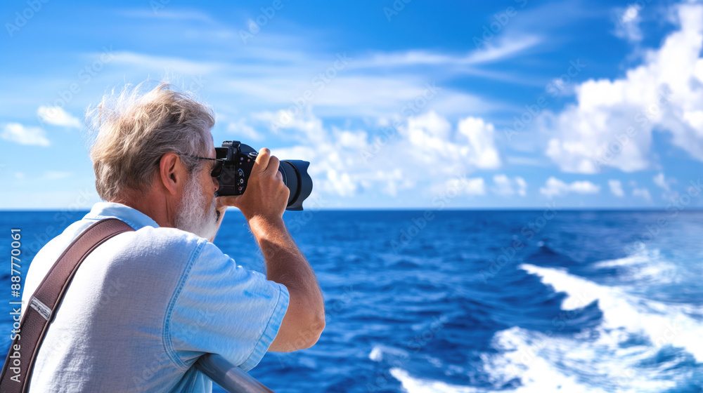 Older man with white beard taking photographs with a DSLR camera on a boat with ocean and blue sky in the background. Older man with white beard taking photographs with a DSLR camera on a boat with ocean and blue sky in the background.