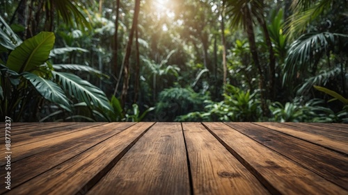 Fototapeta Naklejka Na Ścianę i Meble -  wooden decking with blurred jungle in background, product display mockup.