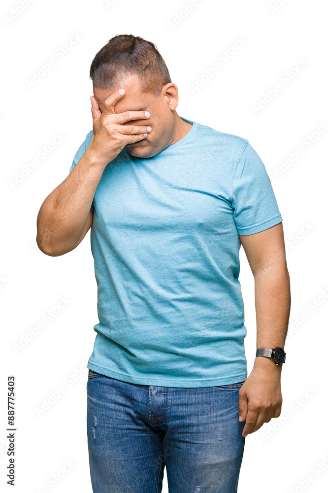Middle age arab man wearing blue t-shirt over isolated background with sad expression covering face with hands while crying. Depression concept. Middle age arab man wearing blue t-shirt over isolated background with sad expression covering face with hands while crying. Depression concept.