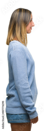 Young beautiful woman wearing winter sweater over isolated background looking to side, relax profile pose with natural face with confident smile.