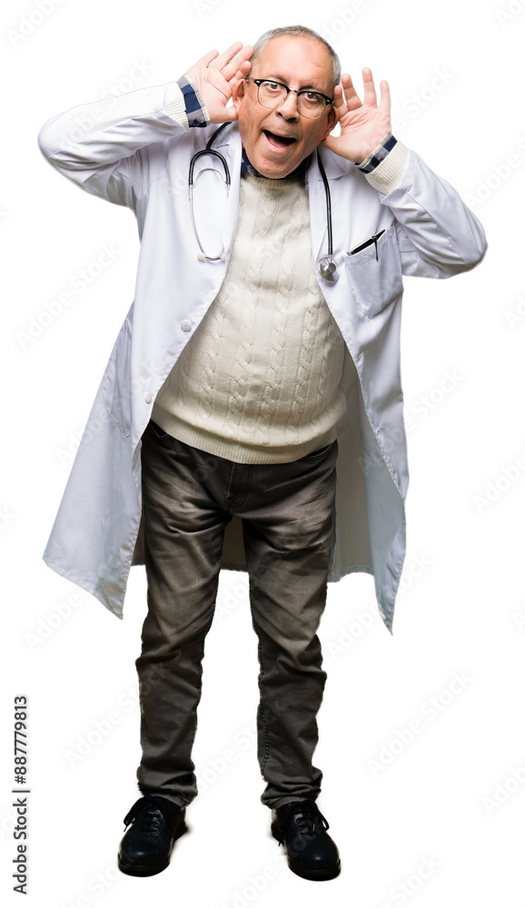 Handsome senior doctor man wearing medical coat Trying to hear both hands on ear gesture, curious for gossip. Hearing problem, deaf Handsome senior doctor man wearing medical coat Trying to hear both hands on ear gesture, curious for gossip. Hearing problem, deaf