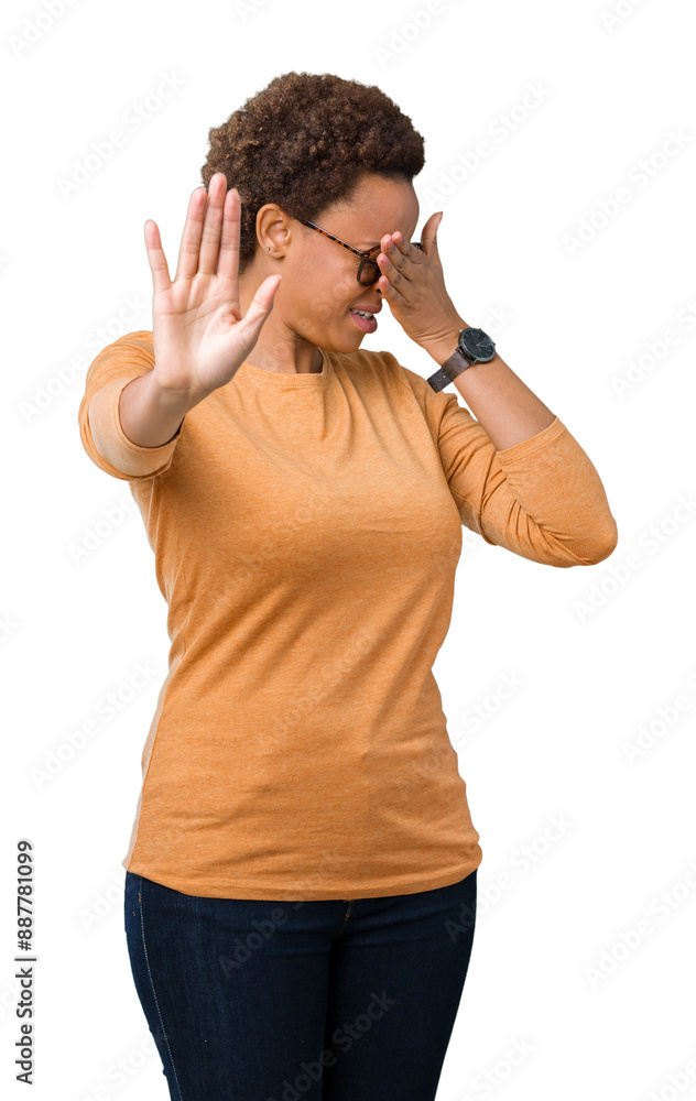 Young beautiful african american woman wearing glasses over isolated background covering eyes with hands and doing stop gesture with sad and fear expression. Embarrassed and negative concept. Young beautiful african american woman wearing glasses over isolated background covering eyes with hands and doing stop gesture with sad and fear expression. Embarrassed and negative concept.