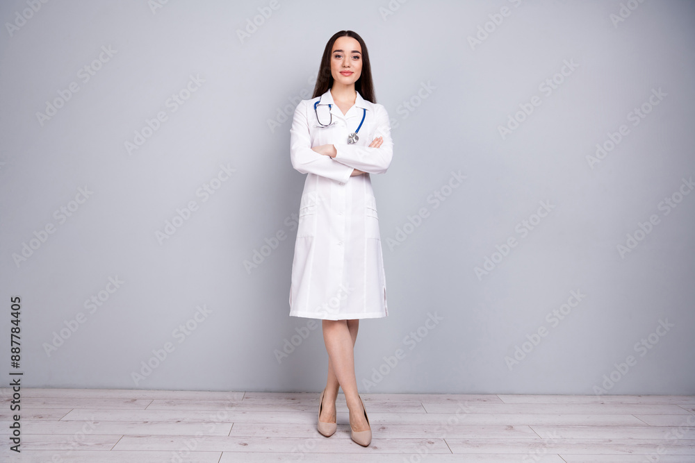 Full size photo of professional medical worker lady folded arms white coat isolated on grey color wall background Full size photo of professional medical worker lady folded arms white coat isolated on grey color wall background