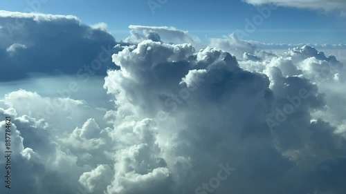 POV flying though a stormy sky full of threatening clouds as seen by the pilots of a jet from the cockpit. 4K 60FPS photo