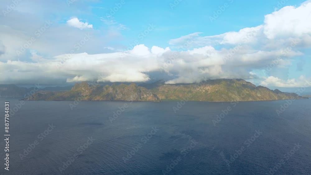 Immerse yourself in the tranquil beauty of the islands near Coron, Philippines, through this serene drone footage. Capturing a clear day, the video provides a static view of the majestic mountainous i Immerse yourself in the tranquil beauty of the islands near Coron, Philippines, through this serene drone footage. Capturing a clear day, the video provides a static view of the majestic mountainous i