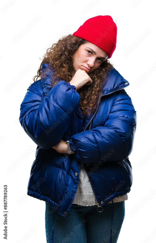 Beautiful young brunette curly hair girl wearing winter coat, wool cap and sweater over isolated background thinking looking tired and bored with depression problems with crossed arms. Beautiful young brunette curly hair girl wearing winter coat, wool cap and sweater over isolated background thinking looking tired and bored with depression problems with crossed arms.