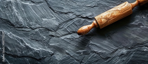 Dark slate surface with rol...