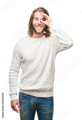 Young handsome man with long hair wearing winter sweater over isolated background doing ok gesture with hand smiling, eye looking through fingers with happy face.