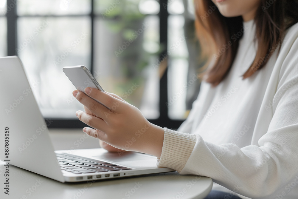 woman using mobile phone, work on laptop computer. woman using mobile phone, work on laptop computer.