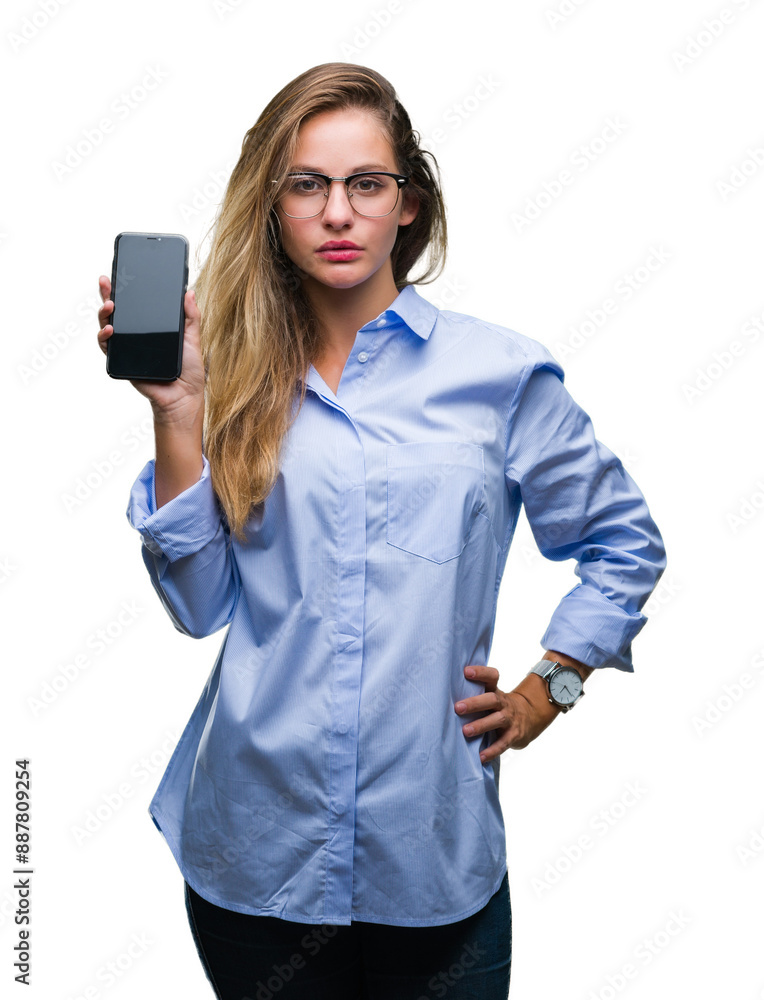 Young beautiful blonde business woman showing screen of smartphone over isolated background with a confident expression on smart face thinking serious Young beautiful blonde business woman showing screen of smartphone over isolated background with a confident expression on smart face thinking serious