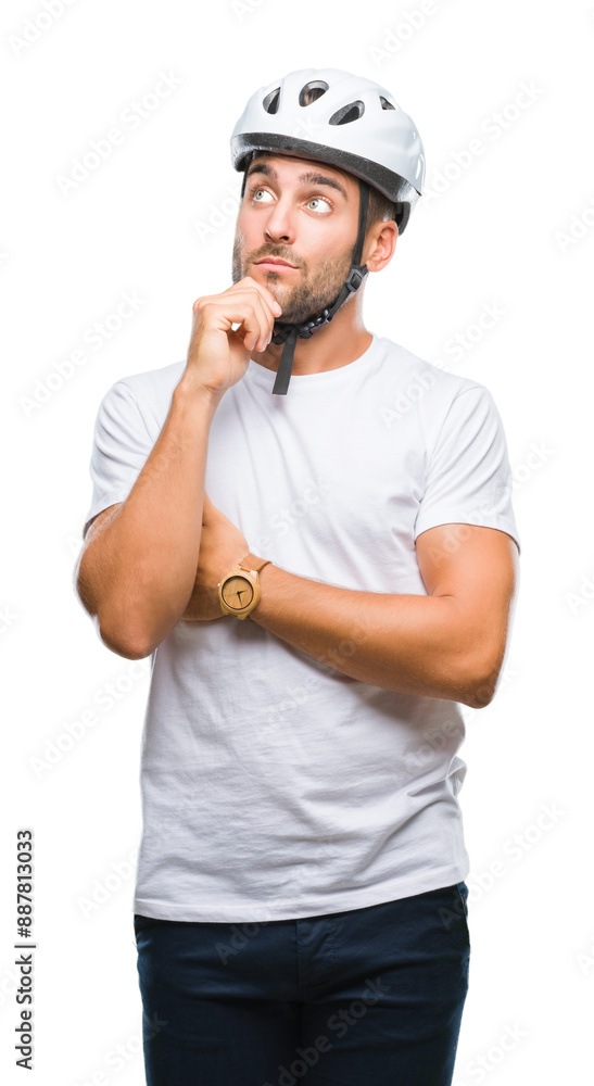 Young handsome man wearing cyclist safety helmet over isolated background with hand on chin thinking about question, pensive expression. Smiling with thoughtful face. Doubt concept. Young handsome man wearing cyclist safety helmet over isolated background with hand on chin thinking about question, pensive expression. Smiling with thoughtful face. Doubt concept.