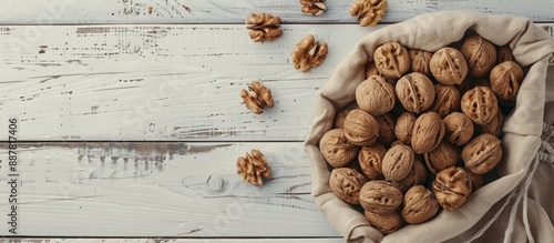 Walnuts arranged on a white...