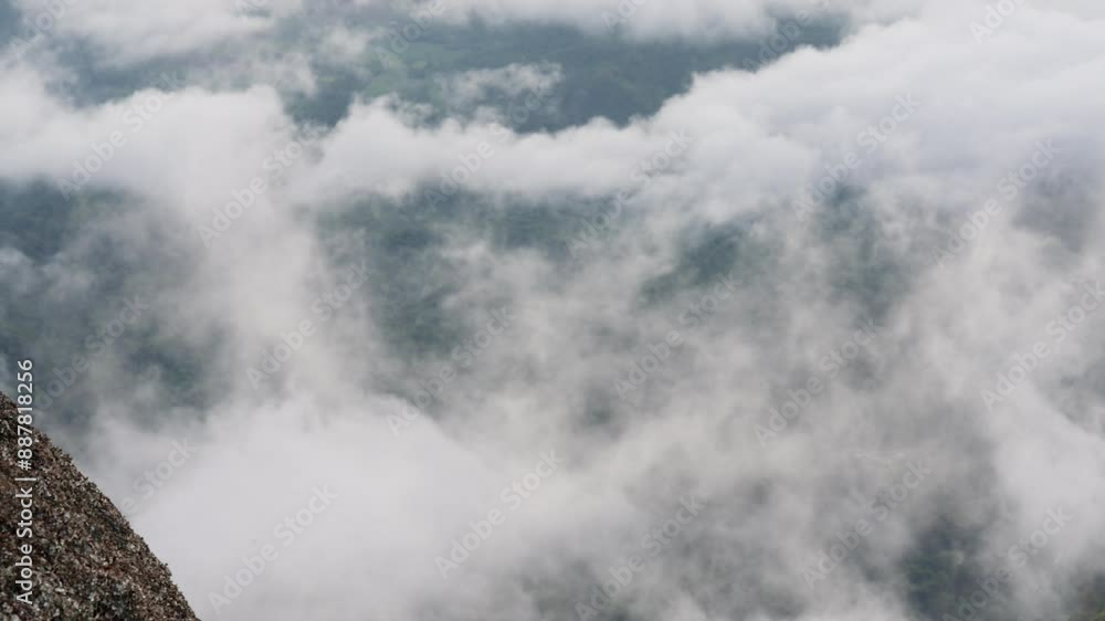 The sky is cloudy and the mountains are covered in mist. The clouds are low and the mountains are in the background The sky is cloudy and the mountains are covered in mist. The clouds are low and the mountains are in the background